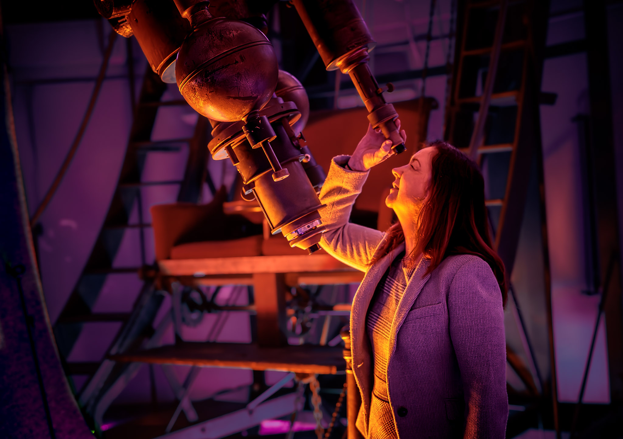 Lisa Kewley, director of the Harvard-Smithsonian Center for Astrophysics and lead author of a new study, peers into the refractor telescope.