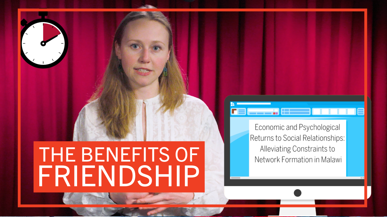 Student Gabriella Fleischman in front of a red curtain with graphics reading “The Benefits of Friendship” and ”Economic and and Psychological Returns to Social Relationships: Alleviating Constraints to Network Formation in Malawi”
