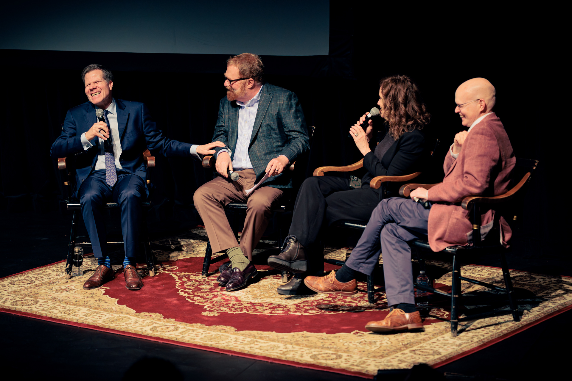 heater director Bill Rauch, at left, laughed onstage during a panel conversation with three alumni who also work in the arts. To Rauch's left, they are: documentary filmmaker R.J. Cutler, actor and producer Amy Brenneman, and Yale School of Drama Dean James Bundy.