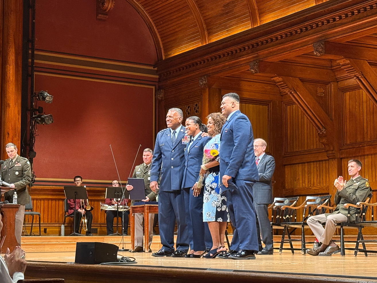 The Clark family poses for a photo on stage.