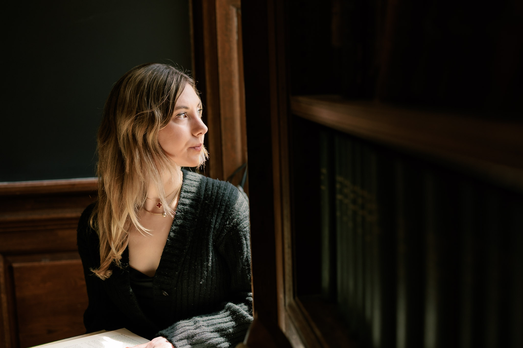Harvard College student Mary Cipperman gazes out a window on campus
