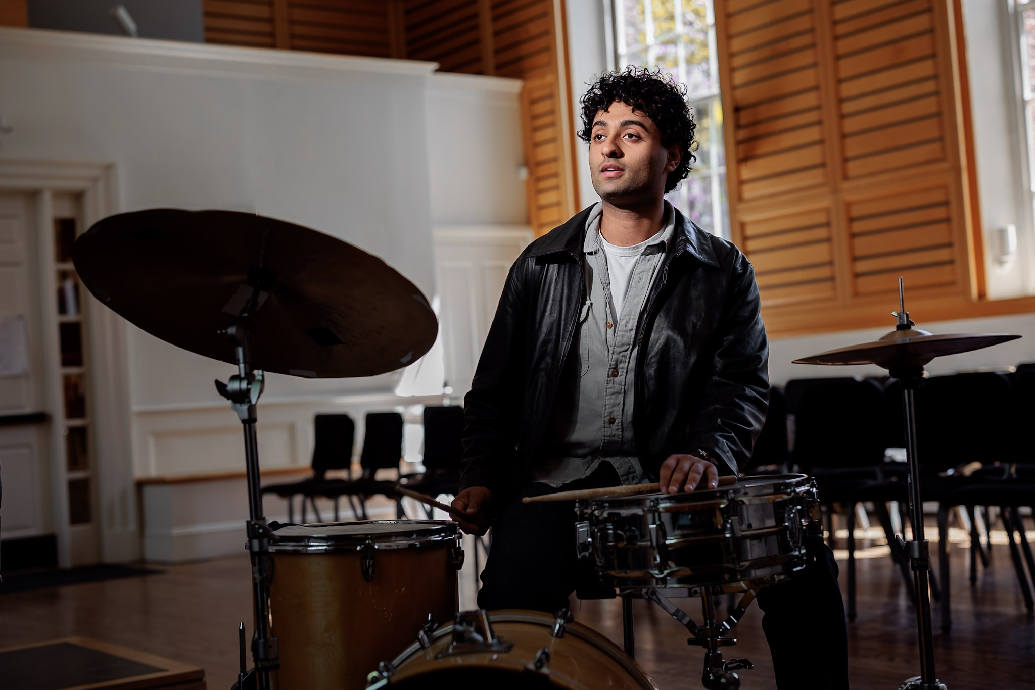 Harvard College senior Raghav Mehrotra, a joint economics and music concentrator, with his drum kit at Holden Chapel.