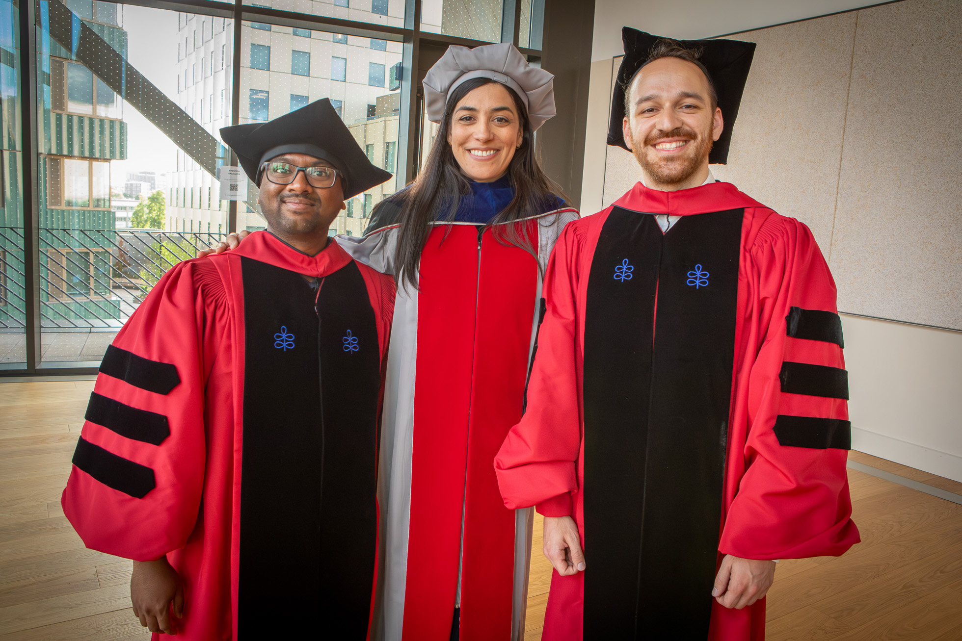 Engineering Professor Stephanie Gil posed with Ph.D. students Ninad Jadhav and Orhan Eren Akgün on Harvard University's Commencement Day.