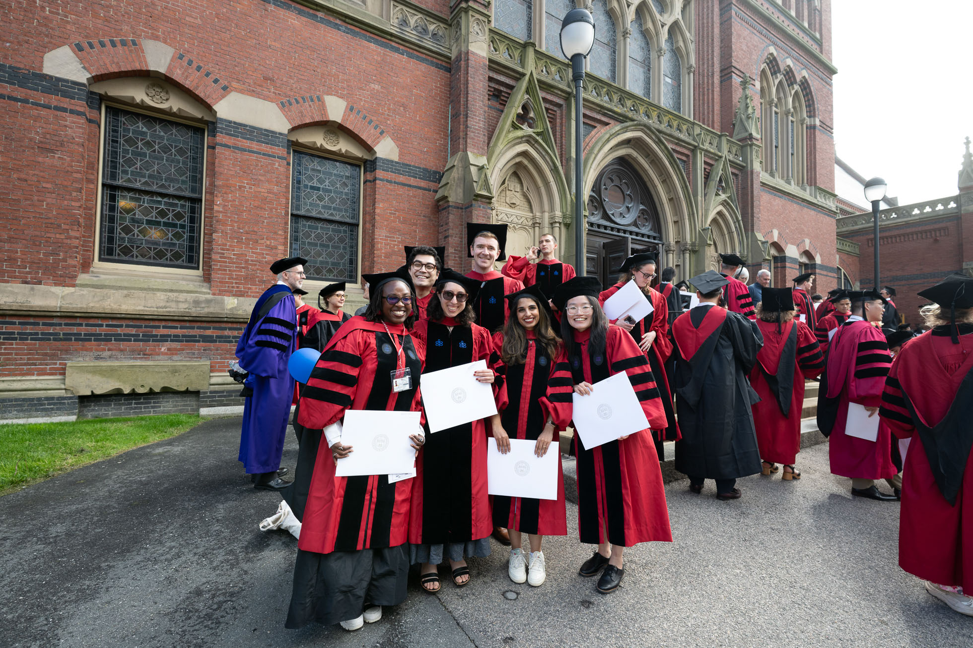 Graduates of the Harvard Kenneth C. Griffin Graduate School of Arts and Sciences celebrated outside their ceremony at Sanders Theatre.