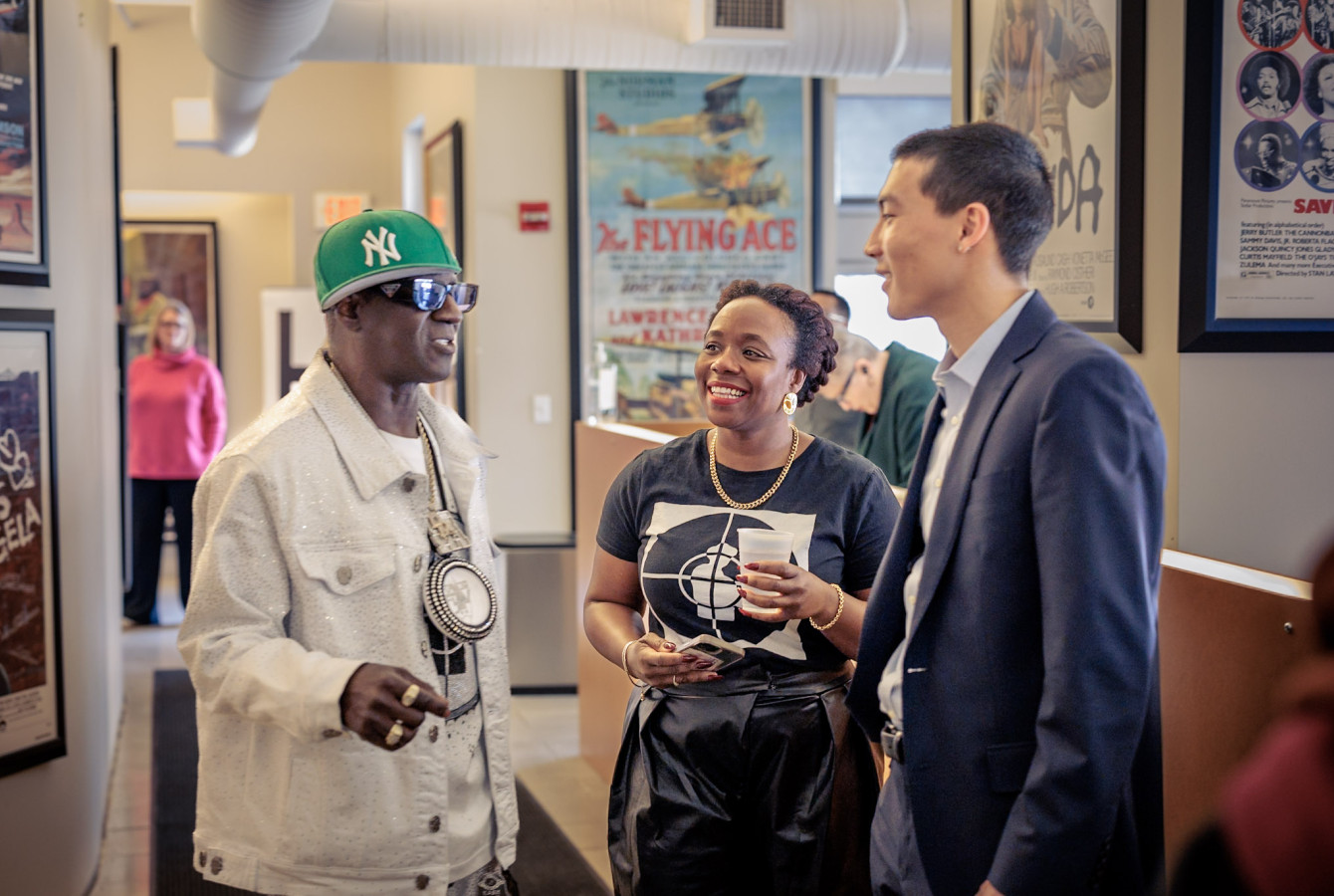 Flavor Flav of the hip-hop group Public Enemy chatted with Alta Mauro, Associate Dean of Culture & Community, and Dexter Griffin ’27 during an appearance at Harvard University’s Marcyliena H. Morgan Hip Hop Archive & Research Institute.
