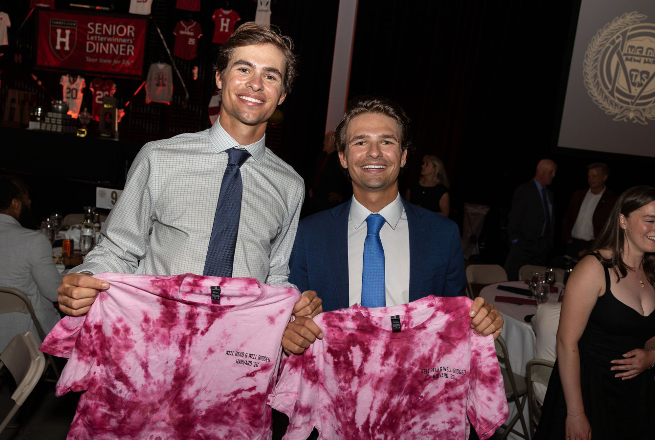Harvard sailors Justin and Mitchell Callahan holding tie-dye T-shirts