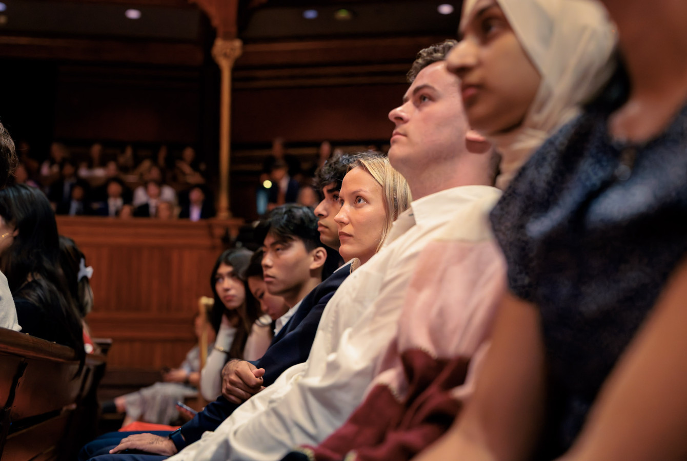First-year Harvard College students listening during the Convocation ceremony for the Class of 2030 at Sanders Theatre