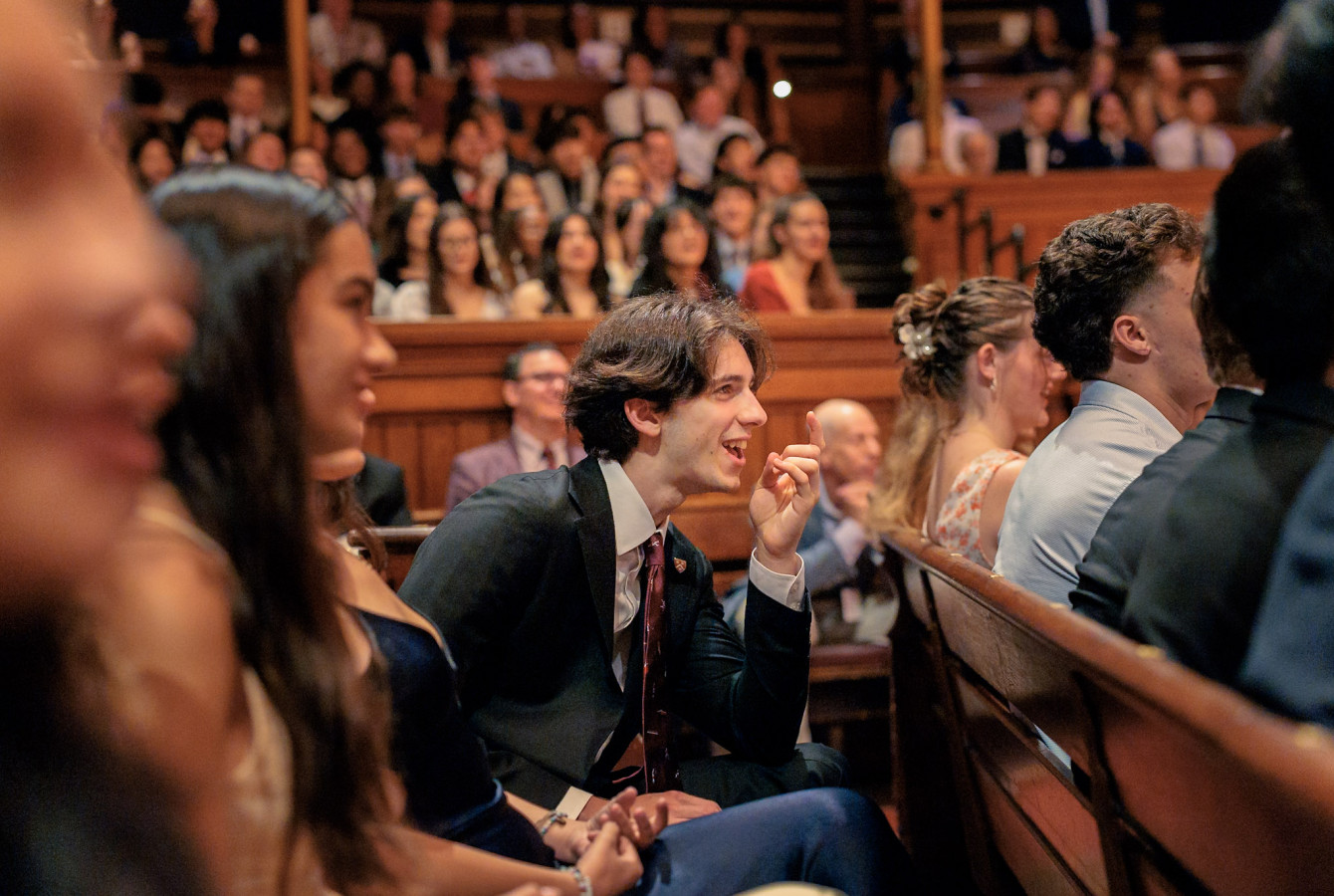 Students in the audience laughing during the Class of 2030 Harvard College Convocation