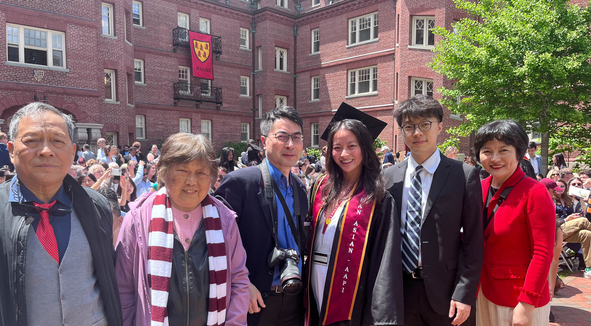 Harvard College graduate Maggie Peng posing for photos at the Adams House diploma ceremony with her parents, brother, and grandparents