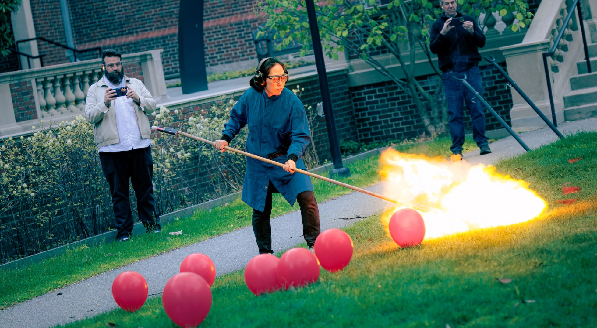 A woman explodes hydrogen balloons with a fire stick to create the cannon fire for Tchaikovsky's 1812 Overture.