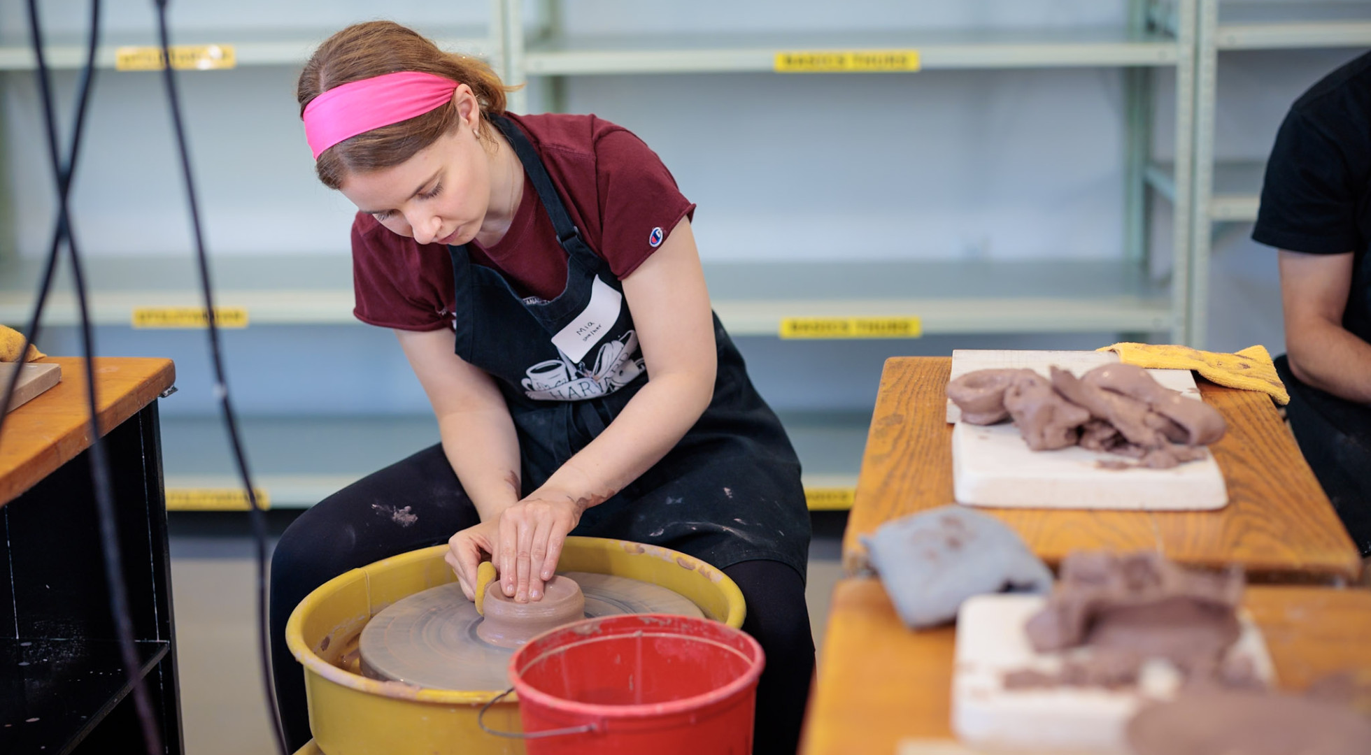 Harvard senior Mia Schenenga at a pottery wheel