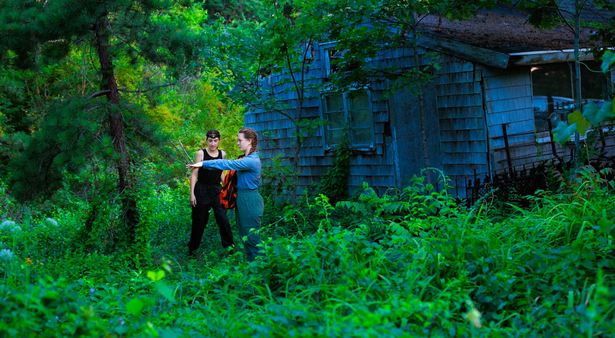 Avalon Owens and Abby Robinson in a field near a cottage