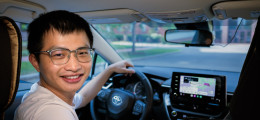 Geophysicist Xiyuan Bao behind the wheel of his car