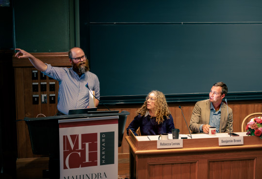 J. Christian Greer lecturing at a podium and pointing