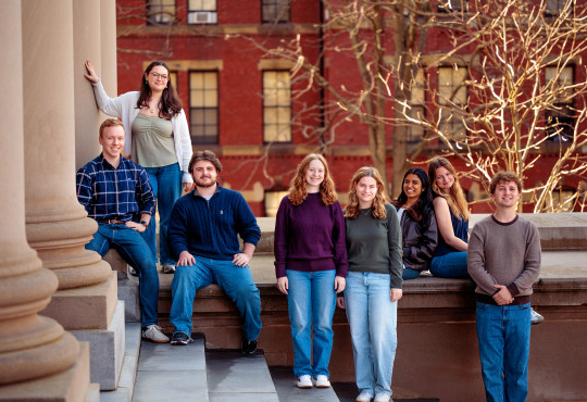A group of students posing on the steps of Widener Library