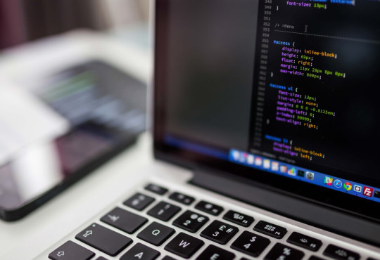 View of a laptop with coding terminal on screen