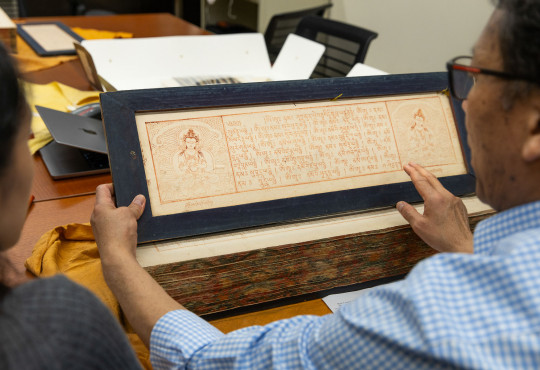 Tibetan language instructor Karma Gongde leads students in examining copies of the Tibetan Buddhist canon at Harvard–Yenching Library.