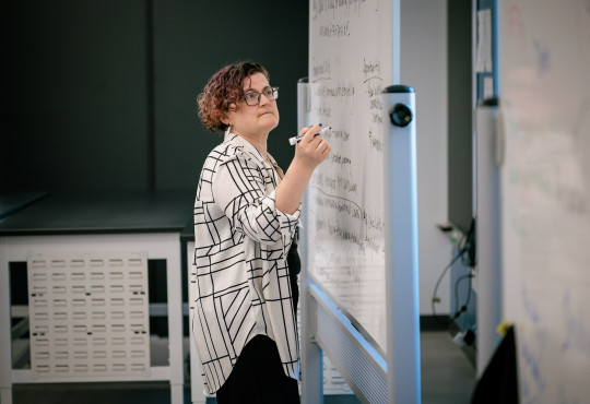 Carrie Diaz Eaton, professor of digital and computational studies at Bates College, at a whiteboard