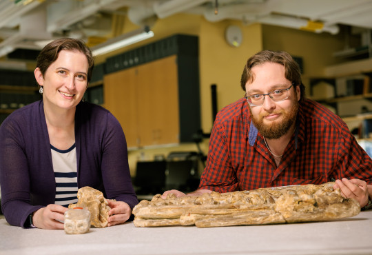 Museum of Comparative Zoology collections manager Christina Byrd, at left, and MCZ fossil preparator Scott Johnston pose with a Tylosaurus proriger fossil jaw.