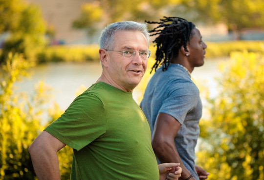 Professor Andrei Shleifer and a student running along the Charles River