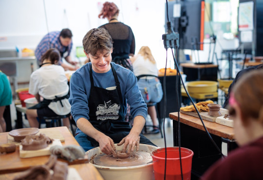 Harvard first-year Beau Chiasson at a pottery wheel