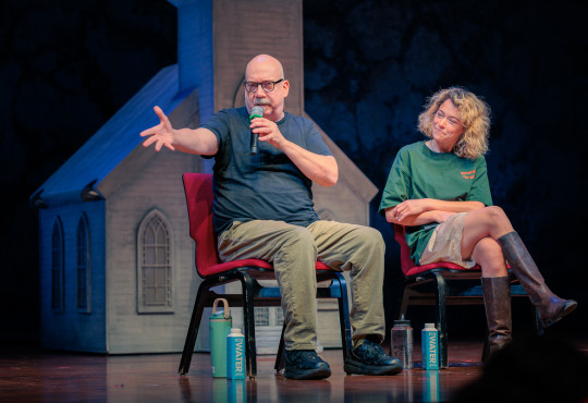 Paul Giamatti and Tatiana Maslany seated on stage at the Loeb Drama Center in a Q&A session