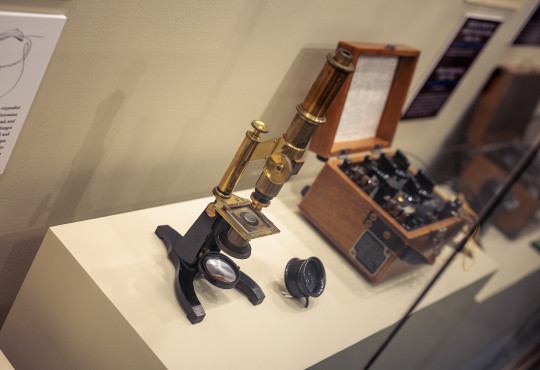 A compound microscope and magnifier on display at the Harvard Collection of Historical Scientific Instruments