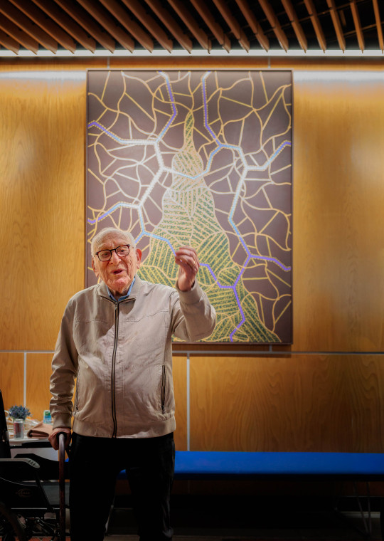 David Bakalar stands before one of his Albert Einstein-inspired “Brain Series” paintings, newly installed on the Harvard University campus at Zimmer Hall.
