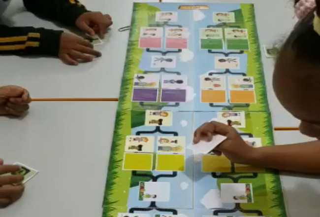 Brazilian children playing a board game from the CuriousMind curriculum