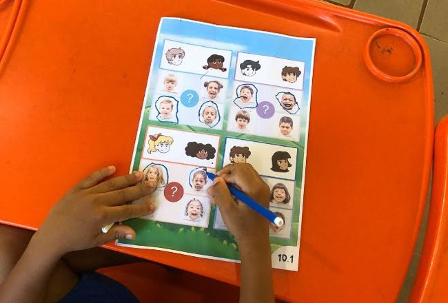 Brazilian children playing a board game from the CuriousMind curriculum