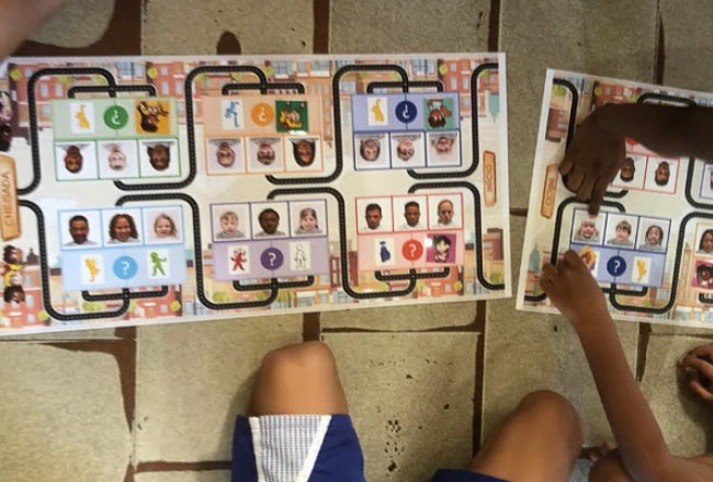 Brazilian children playing a board game from the CuriousMind curriculum