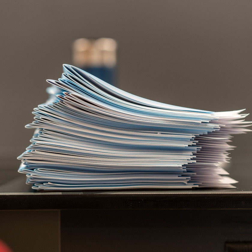 A stack of test blue books. Photo credit David Degner