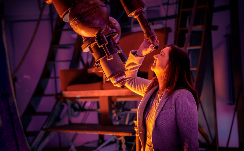 Lisa Kewley, director of the Harvard-Smithsonian Center for Astrophysics and lead author of a new study, peers into the refractor telescope.