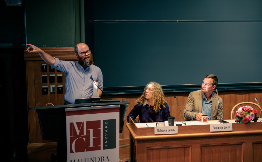 J. Christian Greer lecturing at a podium and pointing