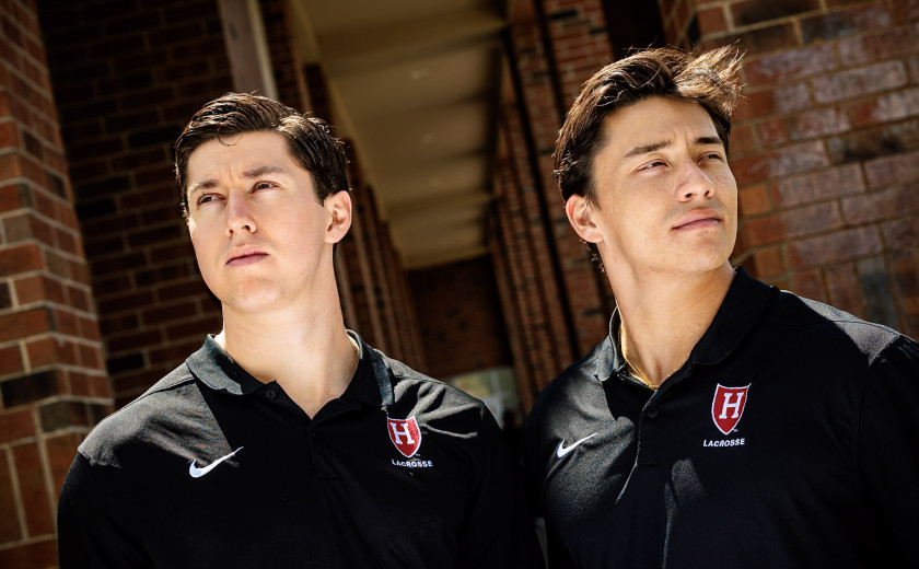 A close-up portrait of Harvard students and lacrosse midfielders Owen Guest, at left, and Francisco Cortes