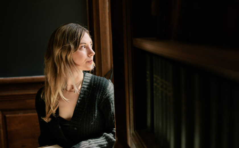 Harvard College student Mary Cipperman gazes out a window on campus
