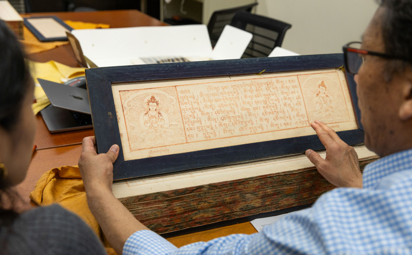 Tibetan language instructor Karma Gongde leads students in examining copies of the Tibetan Buddhist canon at Harvard–Yenching Library.