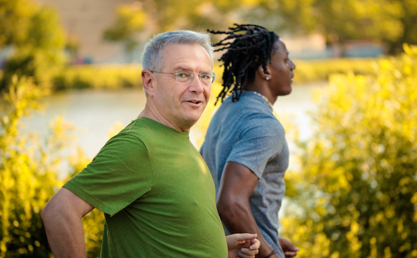 Professor Andrei Shleifer and a student running along the Charles River