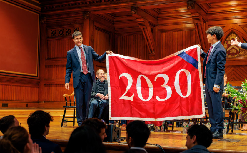 Juniors Zach Berg and Daniel Zhao, co-presidents of the Harvard Undergraduate Association, unfurling a banner welcoming the Class of 2030 at the September 1 Convocation ceremony