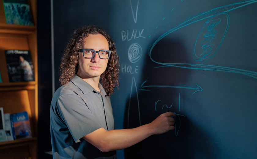 Astrophysicist Sasha Plavin at a blackboard
