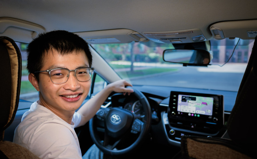 Geophysicist Xiyuan Bao behind the wheel of his car