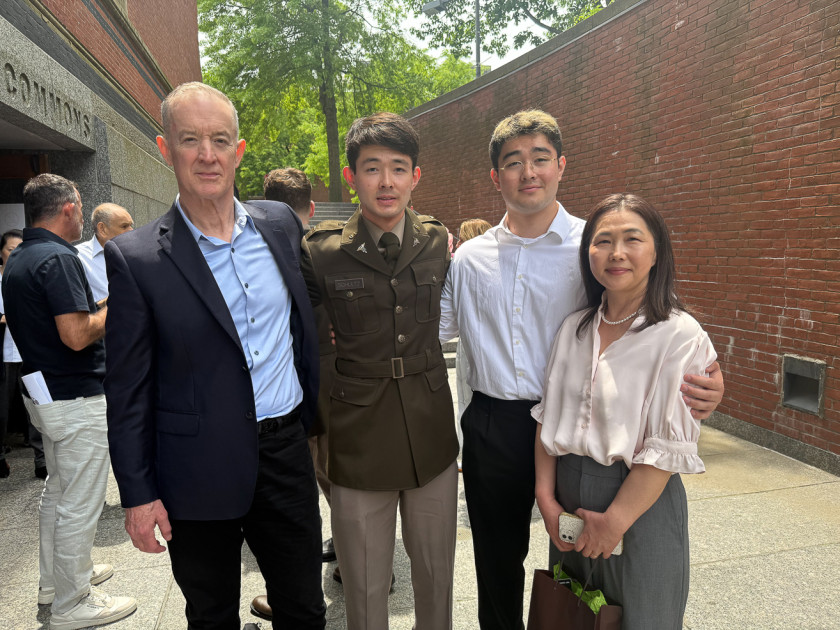Lt. Adler Schultz ’26 with family members outside Sanders Theatre