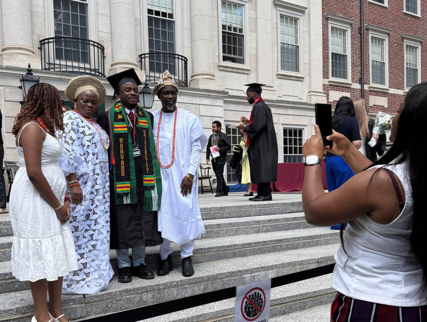 Harvard College graduate Tioluwalase Adelakun posing for photos with family members at Winthrop House