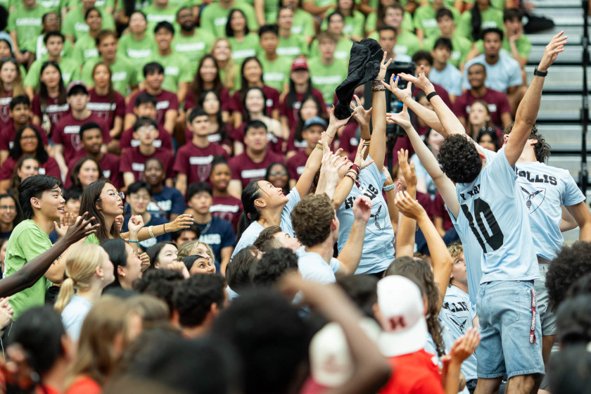 Residents of Hollis Hall, in Ivy Yard, reached for a Crimson-branded T-shirt during a swag toss.