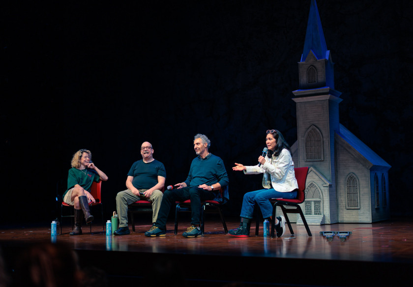 Tatiana Maslany, Paul Giamatti, John Turturro, and Diane Paulus seated on stage at the Loeb Drama Center in a Q&A session