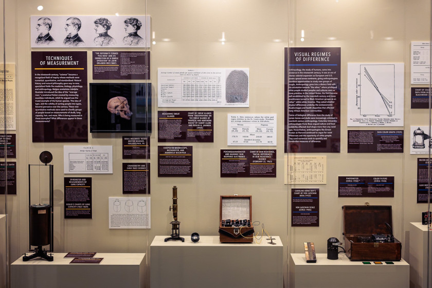 Display cases of historical scientific instruments and accompanying information from the Measurement on the Color Line exhibit