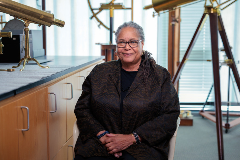 Harvard professor Evelynn Hammonds surrounded by telescopes in Harvard’s Collection of Historical Scientific Instruments