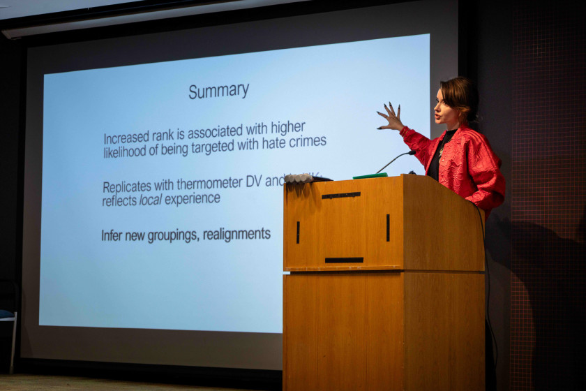 Mina Cikara speaking at a podium
